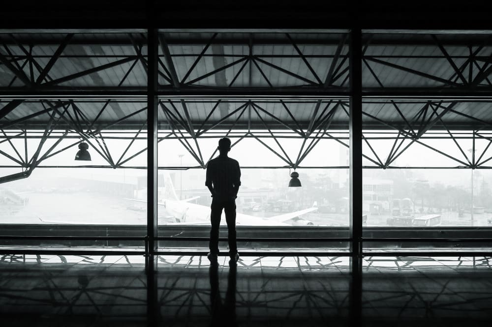 Public Domain Images – .com – Airport Plane Hanger Man Standing Back Foggy Mist Architecture